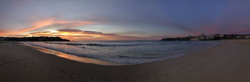 Scenic view of beach against sky during sunset