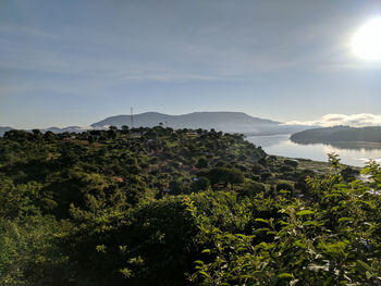 Scenic view of sea and mountains against sky