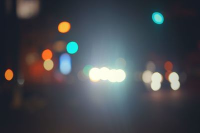 Defocused image of illuminated city at night