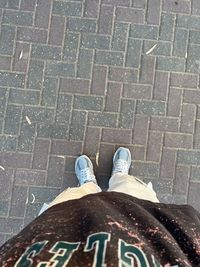 Low section of man standing on footpath