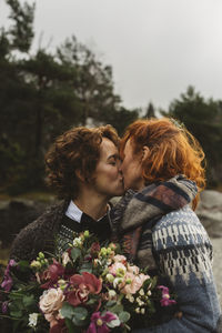 Lesbian couple kissing outdoors