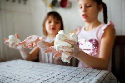 Cute girl playing with foam at home