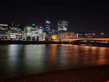 Illuminated city at waterfront