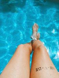 Low section of woman in swimming pool