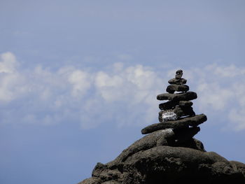 Low angle view of stack of rock against sky