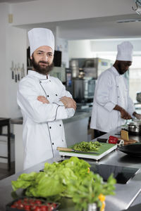 Portrait of smiling female scientist working in kitchen