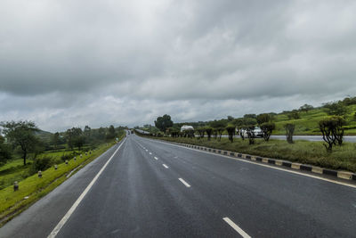 View of highway against cloudy sky