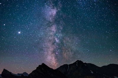 Scenic view of mountains against sky at night