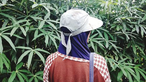 Rear view of woman standing by plants