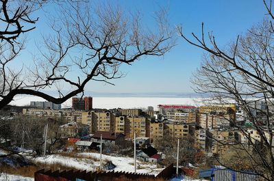 High angle view of buildings and trees against sky