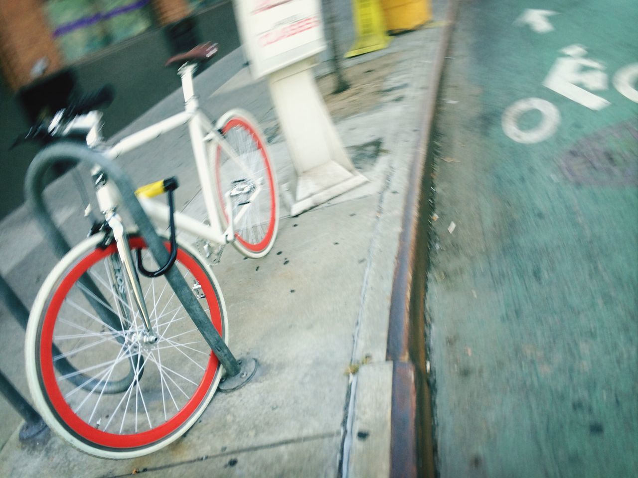 transportation, mode of transport, bicycle, land vehicle, street, stationary, parking, road, text, travel, car, parked, high angle view, wheel, motorcycle, day, outdoors, road marking, incidental people, selective focus