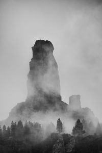 Scenic view of rock formation against sky during foggy weather at pilancones