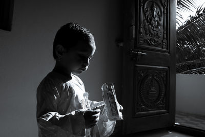 Side view of boy looking at camera