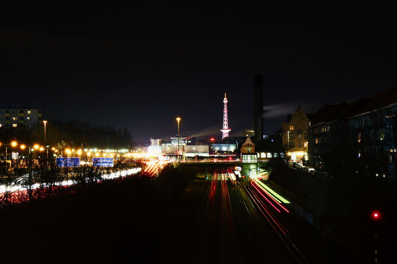 ILLUMINATED CITYSCAPE AGAINST SKY