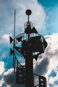 Low angle view of communications tower against sky