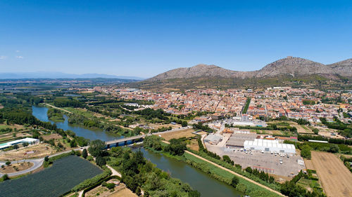 High angle view of townscape against clear blue sky