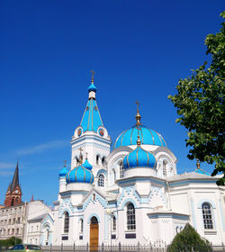 Low angle view of buildings against blue sky