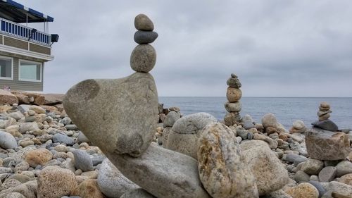 Rocks on beach against sky