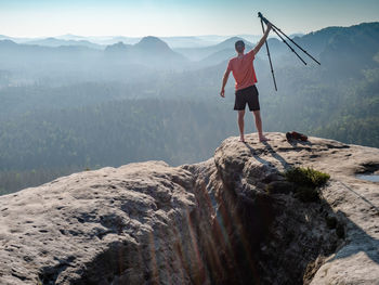 Rear view of man on mountain against sky