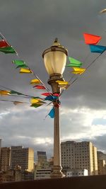 Low angle view of flags hanging against sky