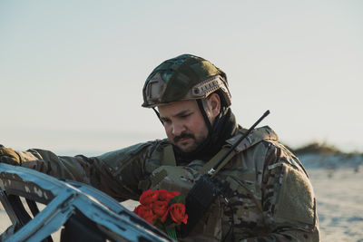 Rear view of man standing against clear sky