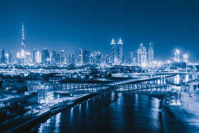 Illuminated modern buildings in city at night