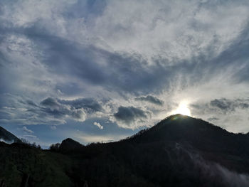 Low angle view of silhouette mountains against sky