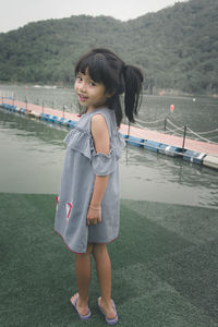 Portrait of smiling girl standing on shore