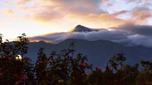 Scenic view of mountains against sky at sunset