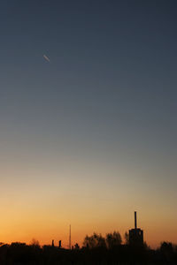 Low angle view of silhouette building against sky during sunset