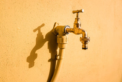 Close-up of faucet on concrete wall