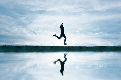 Man jumping against sky