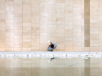 Woman sitting on wall