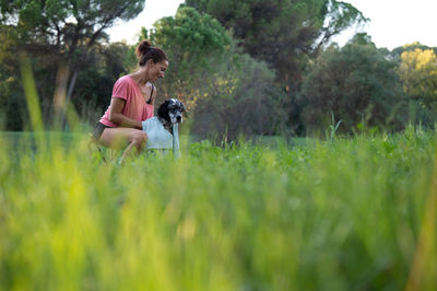 Portrait of young woman standing on field