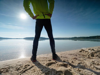 Morning workout. warming up before training. sportsman in sportswear doing stretching on the beach 