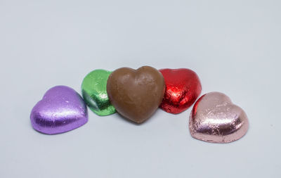 Close-up of multi colored candies against white background