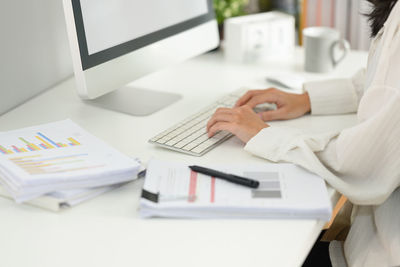 Midsection of woman working on table