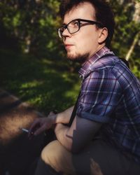 Side view of young man using mobile phone