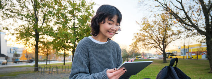 Portrait of young woman using mobile phone