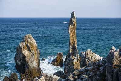 Scenic view of sea with rocks in background