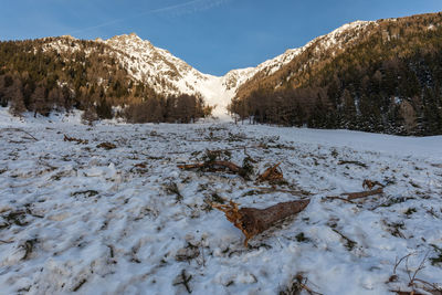 Snow covered landscape against sky