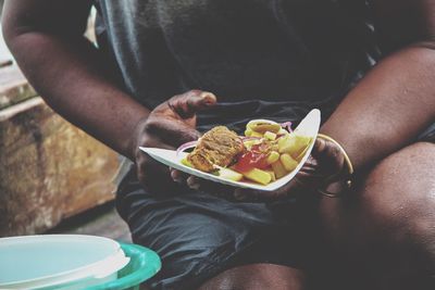 Midsection of person eating food