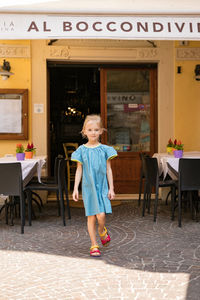 Full length of a girl standing on table