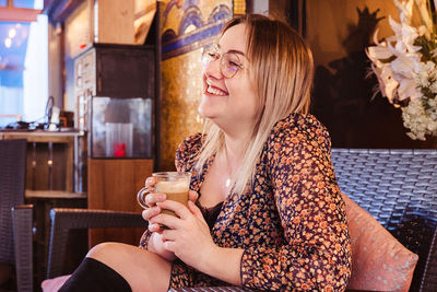 Portrait of beautiful woman drinking glasses outdoors