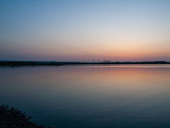 Scenic view of sea against clear sky during sunset