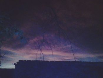 Low angle view of silhouette trees against sky at sunset