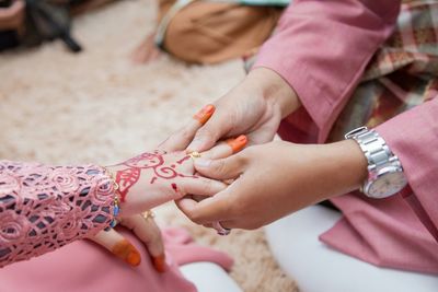 Midsection of couple holding hands