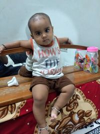 Portrait of cute boy sitting at home