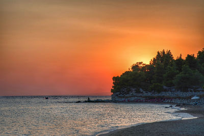 Scenic view of sea against orange sky