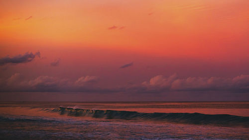 Scenic view of sea against romantic sky at sunset